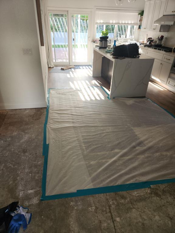 A kitchen with a rug on the floor