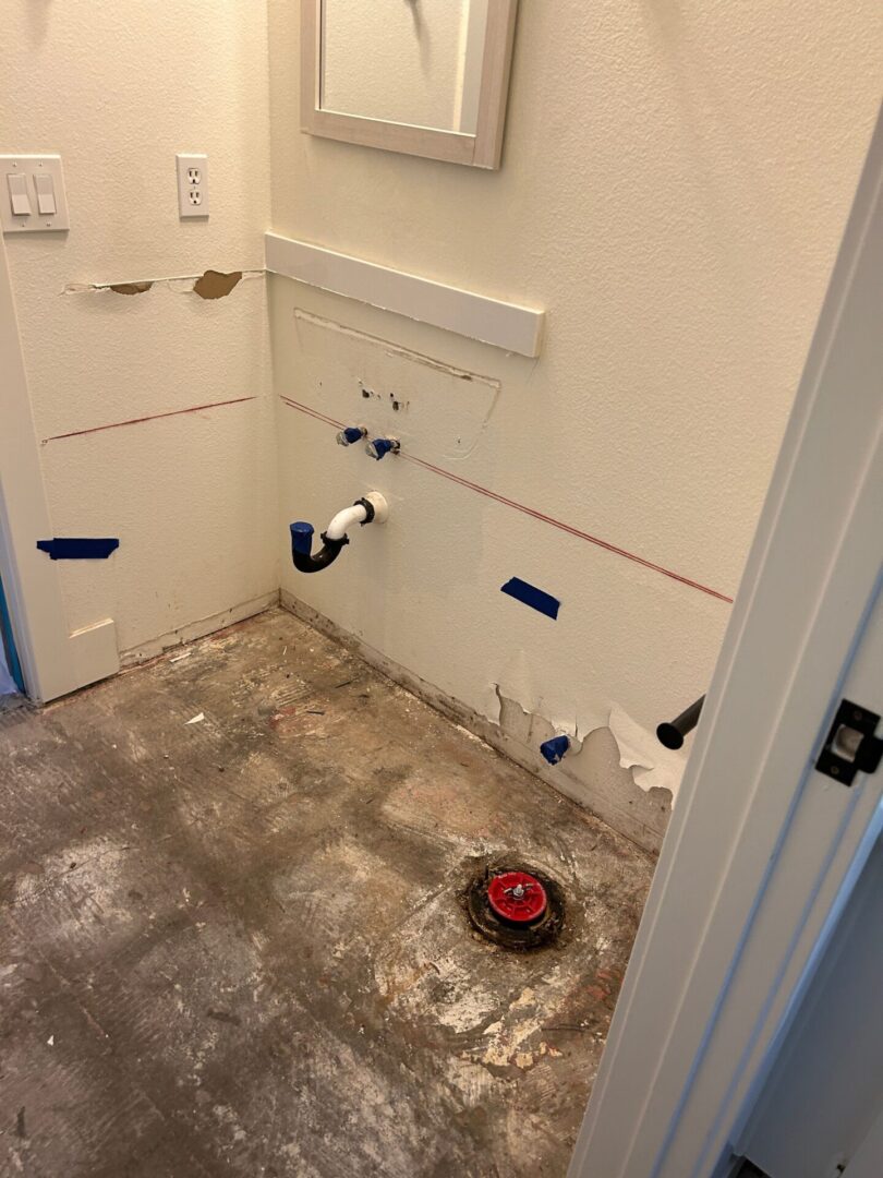 A bathroom with the floor being remodeled and walls in place.